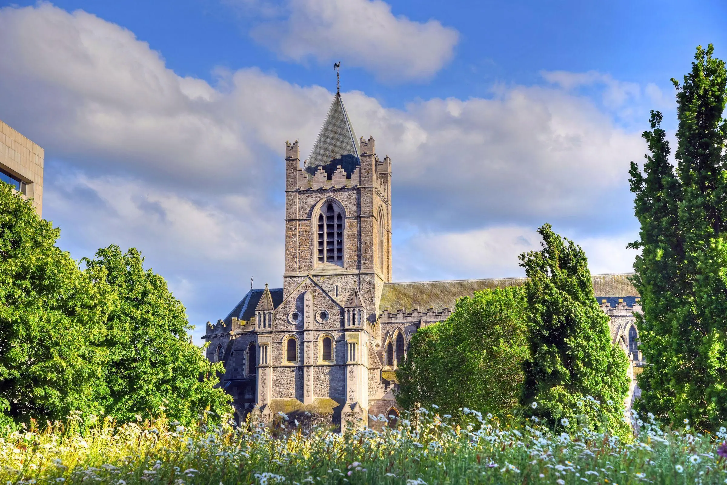 The stone exterior of Christ Church Cathedral in Dublin against a cloudy sky