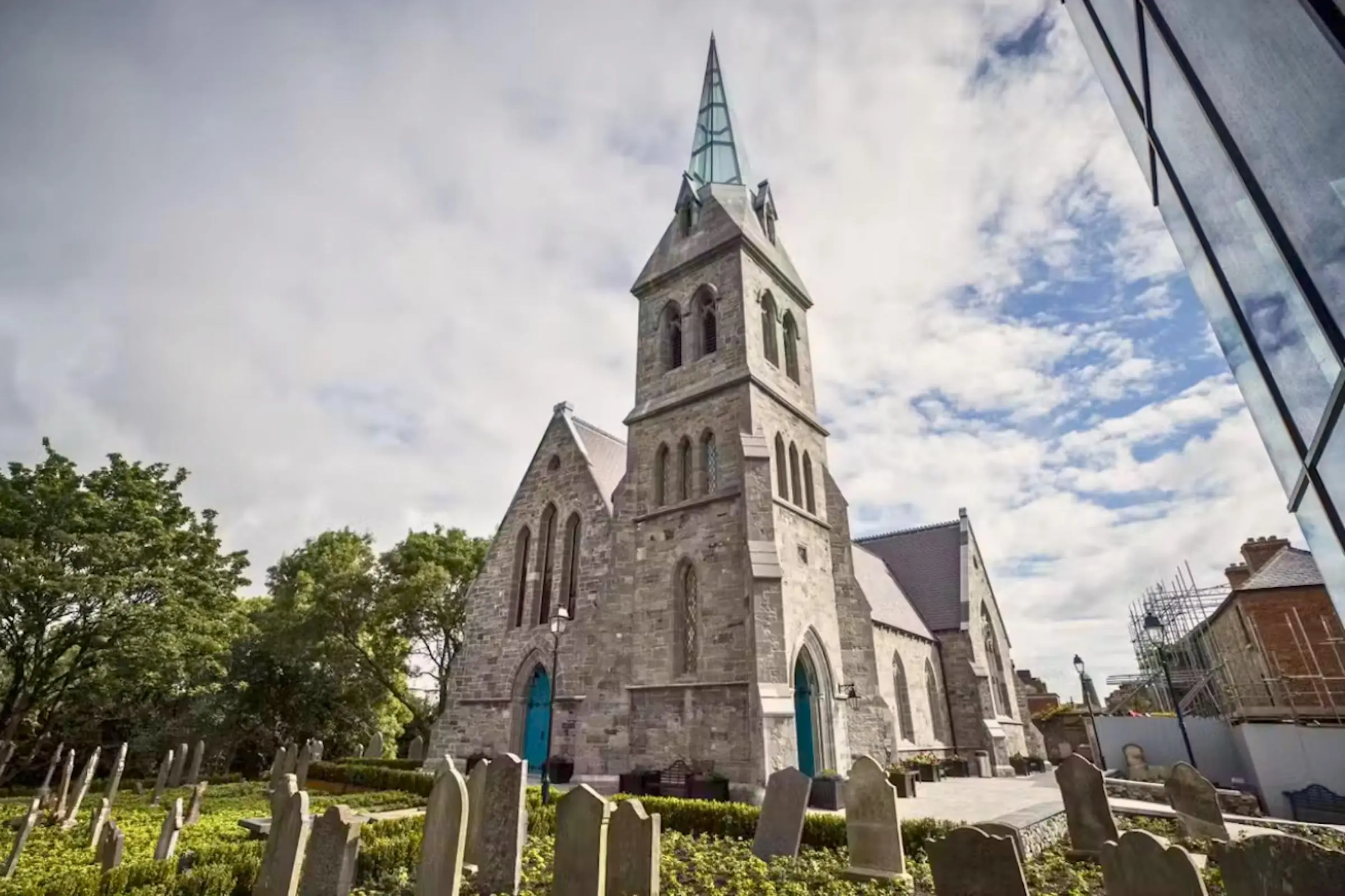 The glass spire and stone facade of St. James's Church, home to Pearse Lyons Distillery